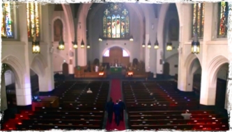 Sam and Dean walk through the church with Father Delany